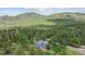 Aerial view of home surrounded by mountain trees at 5939 S Skyline Dr, Evergreen, CO 80439