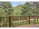 Wooden deck with lovely views of green trees and the road at 5939 S Skyline Dr, Evergreen, CO 80439