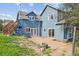 Home exterior with a spacious patio, lush lawn, and mature trees, perfect for outdoor living at 5939 S Skyline Dr, Evergreen, CO 80439