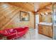 Bathroom featuring wood paneling, a red bathtub, and a vanity with a white countertop at 5939 S Skyline Dr, Evergreen, CO 80439