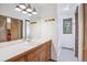 Bathroom with a double vanity, large mirror, and tiled shower/tub combination at 5939 S Skyline Dr, Evergreen, CO 80439