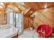 Bathroom features wood paneling, a red bathtub, and a separate shower stall at 5939 S Skyline Dr, Evergreen, CO 80439