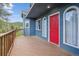 Exterior of the home featuring a vibrant red front door and charming arched windows on a sunny day at 5939 S Skyline Dr, Evergreen, CO 80439