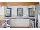 Well-appointed kitchen with white cabinets, stainless steel appliances, blue countertops and a view of the trees at 5939 S Skyline Dr, Evergreen, CO 80439