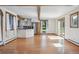 Open-concept living space featuring hardwood floors, stainless appliances, white cabinets and natural light at 5939 S Skyline Dr, Evergreen, CO 80439