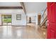 Spacious living room featuring hardwood floors, exposed beam and a fireplace, with natural light from glass doors at 5939 S Skyline Dr, Evergreen, CO 80439