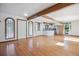 Bright open-concept living space featuring hardwood floors, stainless appliances, white cabinets and natural light at 5939 S Skyline Dr, Evergreen, CO 80439