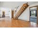 Living room features hardwood floors, staircase with white spindles, and a wood-burning stove at 5939 S Skyline Dr, Evergreen, CO 80439