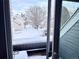 View from deck shows snow covered homes and trees at 8701 Huron St # 3-214, Thornton, CO 80260