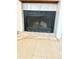 Close-up of a fireplace featuring neutral tiles and stylish hardwood flooring at 8701 Huron St # 3-214, Thornton, CO 80260