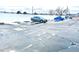 Exterior view of a snow-covered parking lot with cars at 8701 Huron St # 3-214, Thornton, CO 80260