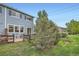 Spacious backyard with lush greenery, a patio, and partial fencing for privacy at 389 Smith Cir, Erie, CO 80516