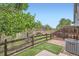 Charming backyard with a wooden fence, brick-paved patio, and well-maintained lawn at 389 Smith Cir, Erie, CO 80516
