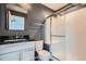 Updated bathroom with glass enclosed shower and dark gray accent wall at 389 Smith Cir, Erie, CO 80516