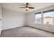 Neutral bedroom with two windows and ceiling fan, ready for personalization at 389 Smith Cir, Erie, CO 80516
