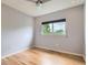 Bright bedroom featuring hardwood floors, a ceiling fan, and a window offering natural light at 389 Smith Cir, Erie, CO 80516