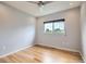 Bright bedroom featuring hardwood floors, a ceiling fan, and a window offering natural light at 389 Smith Cir, Erie, CO 80516
