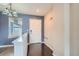 Bright entryway with hardwood floors, blue accent wall, and modern lighting fixture at 389 Smith Cir, Erie, CO 80516
