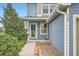 Charming blue home with a welcoming front entrance and landscaped walkway at 389 Smith Cir, Erie, CO 80516