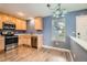 Eat-in kitchen featuring stainless appliances, a window, and modern lighting at 389 Smith Cir, Erie, CO 80516