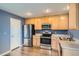 Updated kitchen with stainless steel appliances and light wood cabinets at 389 Smith Cir, Erie, CO 80516
