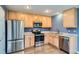 Bright kitchen featuring stainless steel appliances and light wood cabinetry at 389 Smith Cir, Erie, CO 80516