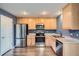 Updated kitchen with stainless steel appliances and light wood cabinets at 389 Smith Cir, Erie, CO 80516