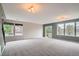 Bright living room featuring carpet, large windows, and a sliding glass door at 389 Smith Cir, Erie, CO 80516