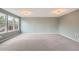 Large, carpeted living room with multiple windows providing ample natural light at 389 Smith Cir, Erie, CO 80516