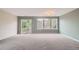 Bright living room featuring a sliding glass door and large windows with a view at 389 Smith Cir, Erie, CO 80516