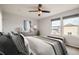 Serene main bedroom showcasing a ceiling fan, neutral decor, and a cozy seating area by the windows at 389 Smith Cir, Erie, CO 80516