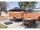 Outdoor patio with a dining table, seating area, and shade provided by a large umbrella at 4571 Beach Ct, Denver, CO 80211