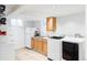 Finished basement with laundry area, including a washer, dryer, sink, and storage at 4571 Beach Ct, Denver, CO 80211