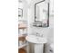 A stylish bathroom features a pedestal sink, built-in shelves, and a modern mirror at 4571 Beach Ct, Denver, CO 80211