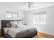 Bright bedroom features wood floors, a ceiling fan, and natural light from two windows at 4571 Beach Ct, Denver, CO 80211