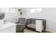A cozy Bedroom with a chair, crib, and shelves with books to create a welcoming space at 4571 Beach Ct, Denver, CO 80211