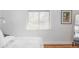 A bright bedroom with hardwood floors, a window, and a modern wall decoration at 4571 Beach Ct, Denver, CO 80211