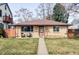 Charming brick home with walkway and well-maintained lawn, plus chairs on porch at 4571 Beach Ct, Denver, CO 80211