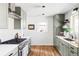Well-lit kitchen featuring modern cabinets and stainless steel appliances at 4571 Beach Ct, Denver, CO 80211