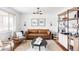 Modern living room featuring a stylish brown leather sofa and neutral decor at 4571 Beach Ct, Denver, CO 80211