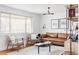 Bright living room featuring a stylish leather sofa and ample natural light at 4571 Beach Ct, Denver, CO 80211