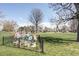 Serene park view with metal flower installations and vibrant green grass under a clear blue sky at 4571 Beach Ct, Denver, CO 80211
