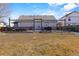 Spacious backyard view featuring wood fencing, a patio area, and a well-maintained lawn at 2321 Ance St, Strasburg, CO 80136