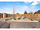 Backyard fire pit area with Adirondack chairs offers a great space for outdoor relaxation at 2321 Ance St, Strasburg, CO 80136