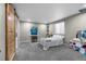 Cozy bedroom with plush carpeting, a bright window, and charming decor touches at 2321 Ance St, Strasburg, CO 80136