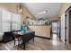 Bright dining area with a pendant light fixture and a large window for lots of natural light at 2321 Ance St, Strasburg, CO 80136