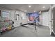 Well-lit exercise room featuring workout equipment and a large mirror for convenient home fitness at 2321 Ance St, Strasburg, CO 80136