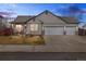 Charming single-story home featuring a three-car garage and a well-manicured front yard at 2321 Ance St, Strasburg, CO 80136