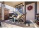 Inviting covered front porch with seating, a wreath, and brick accents at 2321 Ance St, Strasburg, CO 80136