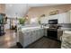 Modern kitchen with white subway tile backsplash and views of the connected living room at 2321 Ance St, Strasburg, CO 80136